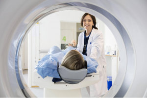 A doctor working with a patient undergoing a CT scan. 
